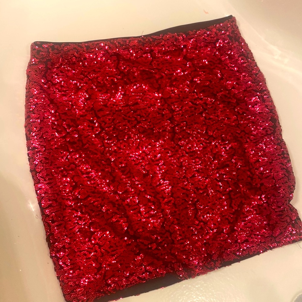 Sequin mini skirt by DIVIDED by H and M size med. color is like a dark pink.
